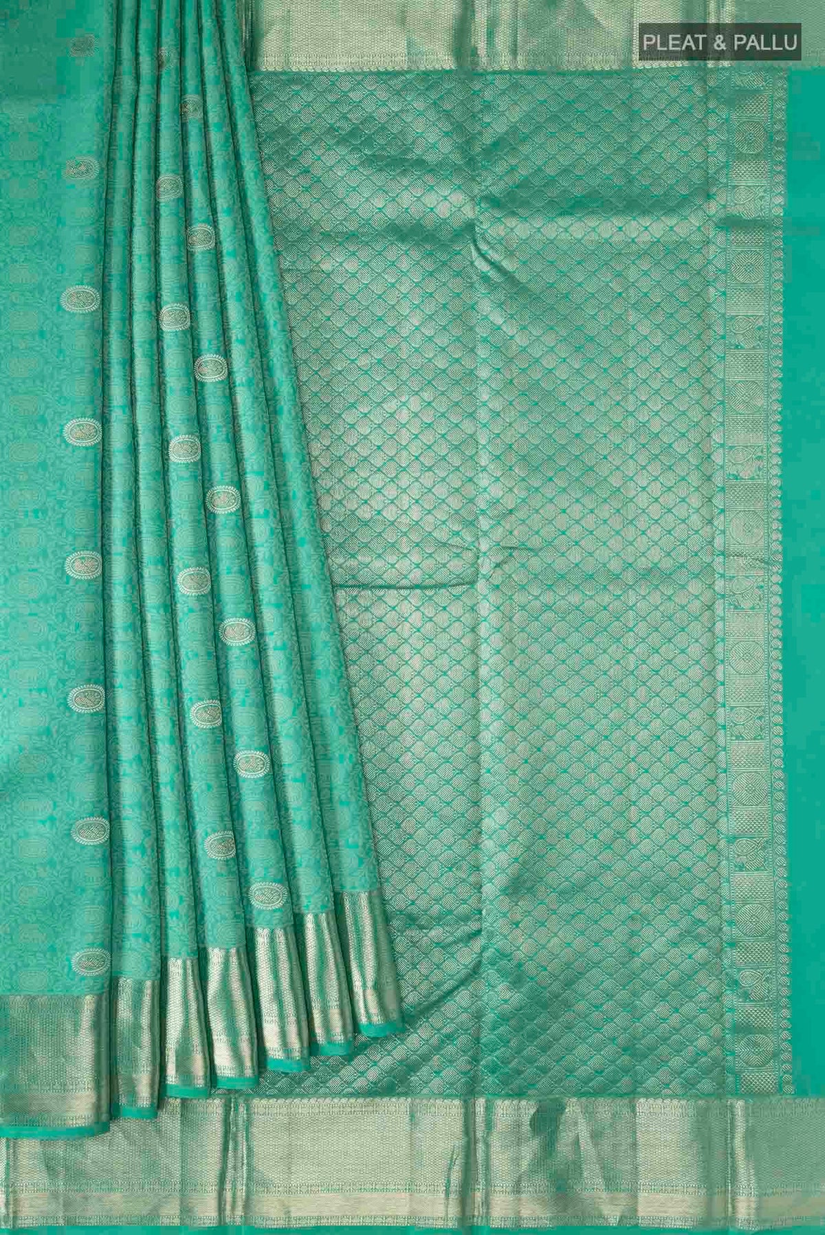 Pleats and pallu of Turquoise Kanchipuram Silk Saree with Zari And Thread Butta on the body and Zari Border