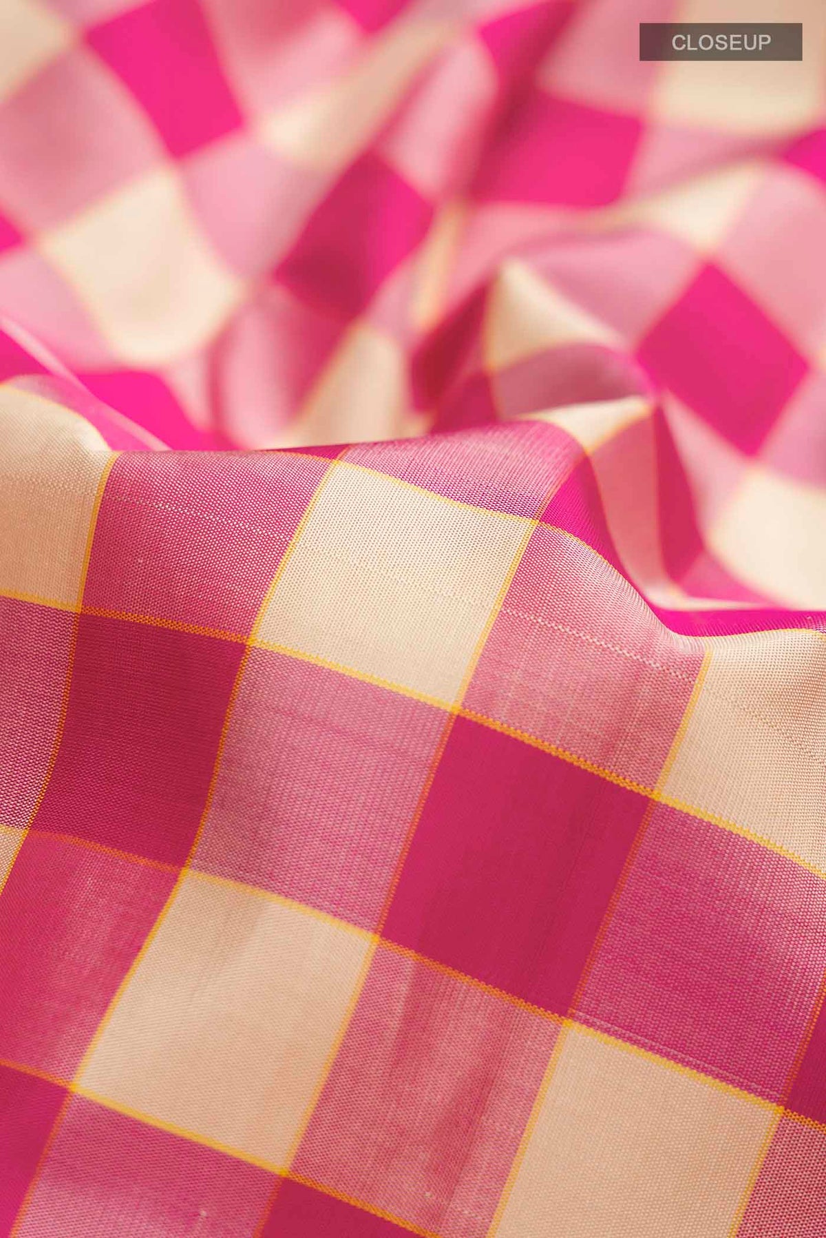Close up of Multi Color Kanchipuram Silk Saree with Checked design on the body and Thread Border displaying folds