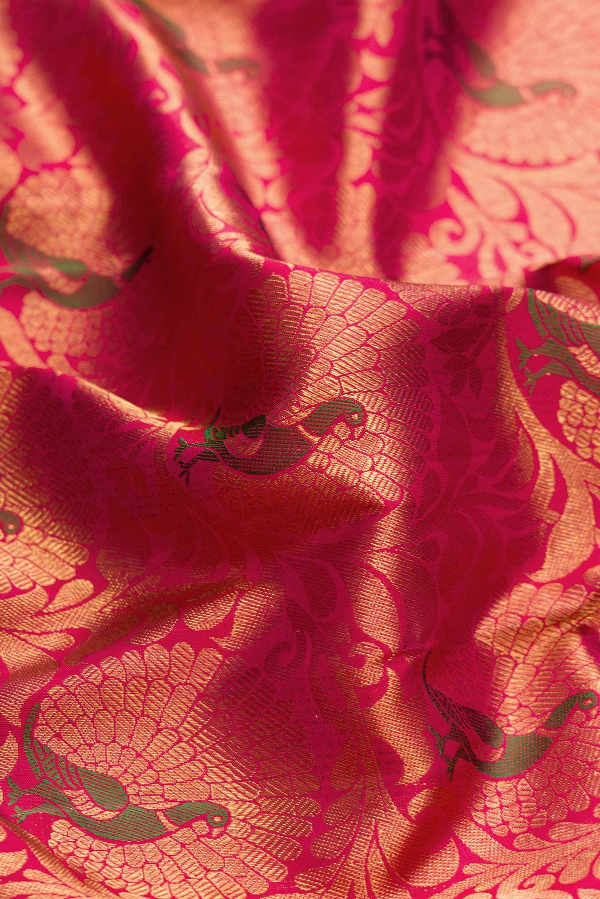 Close up of Pure Silk Pure Zari Dark Pink Dual Tone Kanchipuram Saree with Zari Brocade on the body and Zari Border displaying folds