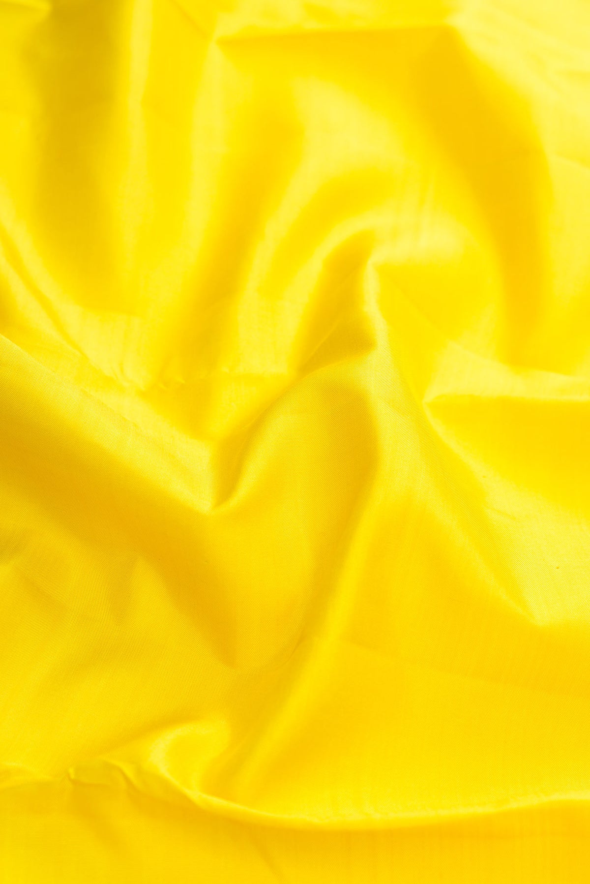 Close up of Yellow Kanchipuram Silk Saree with Plain Body and Thread Border displaying folds