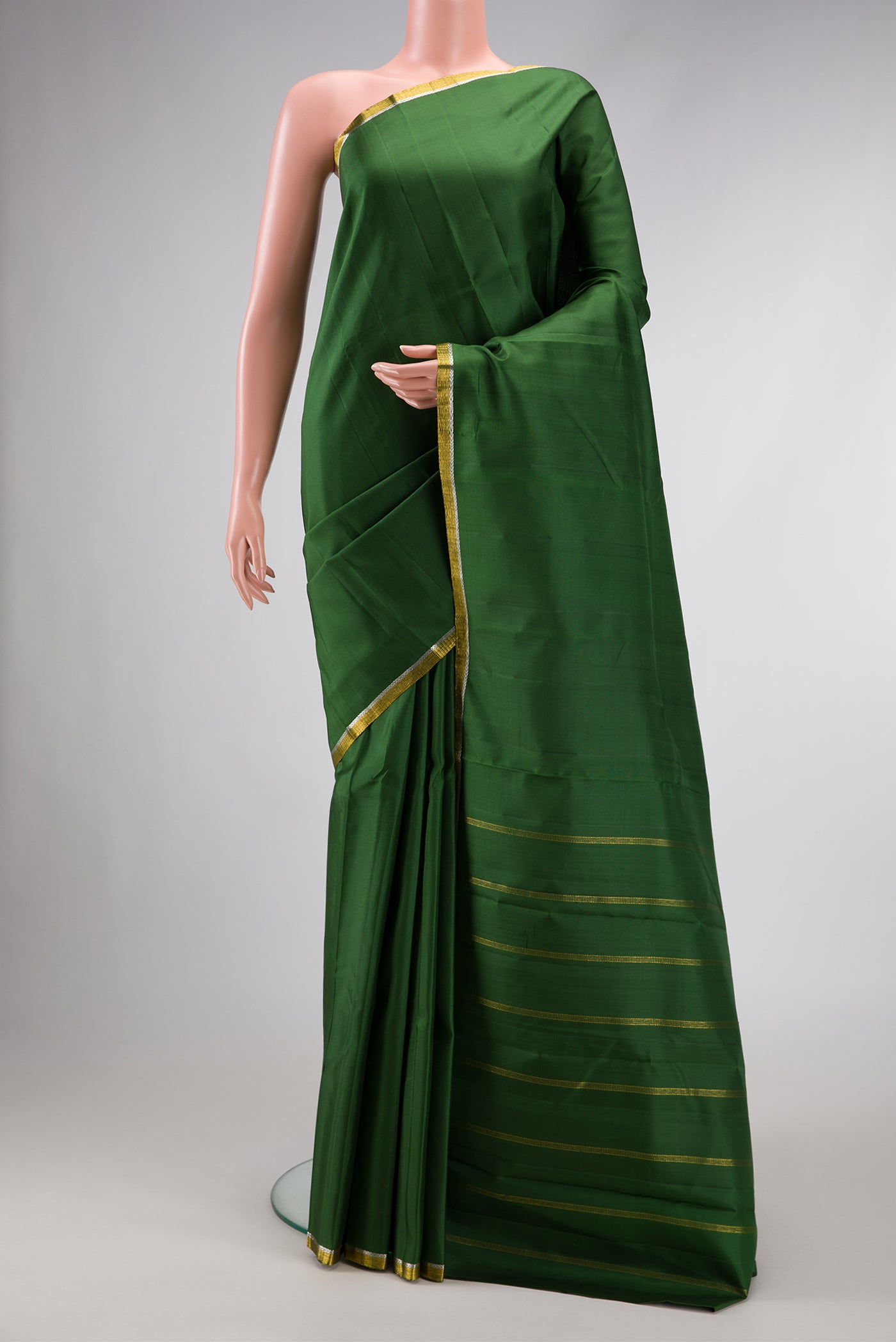 Bottle Green Dual Tone Soft Silk Saree with Plain Body and Zari Border.  displayed on a mannequin