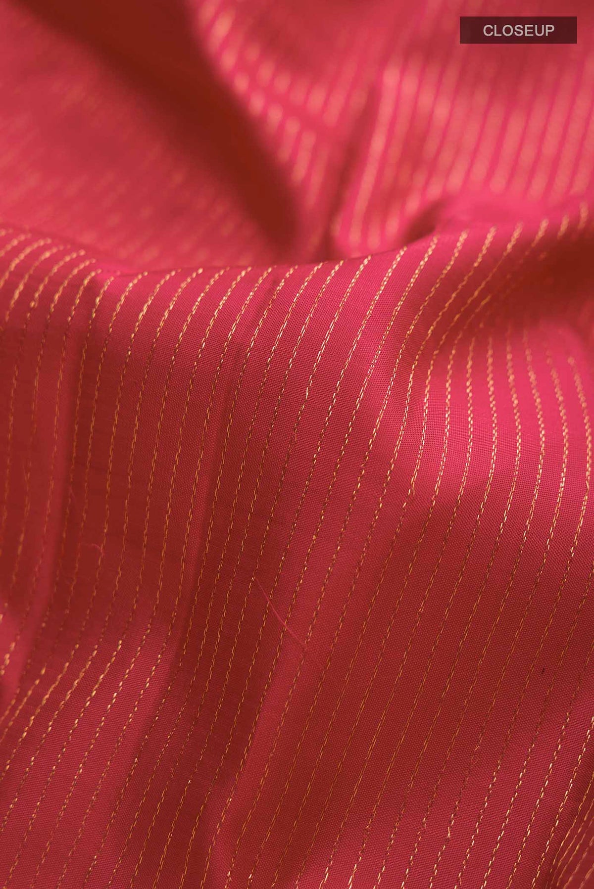 Close up of Maroon Kanchipuram Silk Saree with Stripes on the body and Zari Border displaying folds