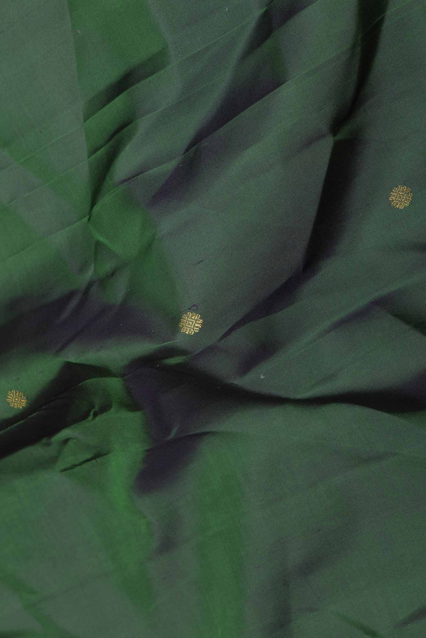Close up of Green Dual Tone Kanchipuram Saree with Zari Butta on the body and Zari Border displaying folds