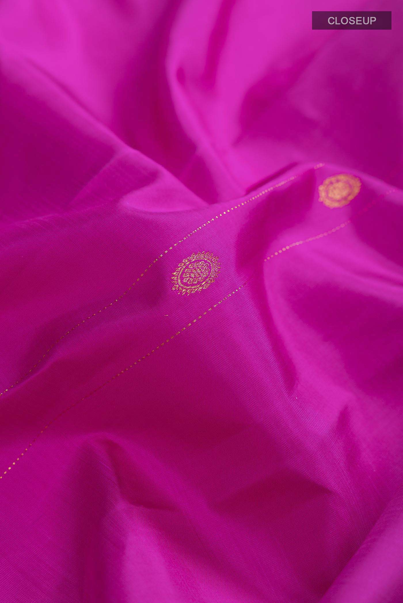 Close up of Pink Kanchipuram Silk Saree with Zari Butta on the body and Without Border displaying folds