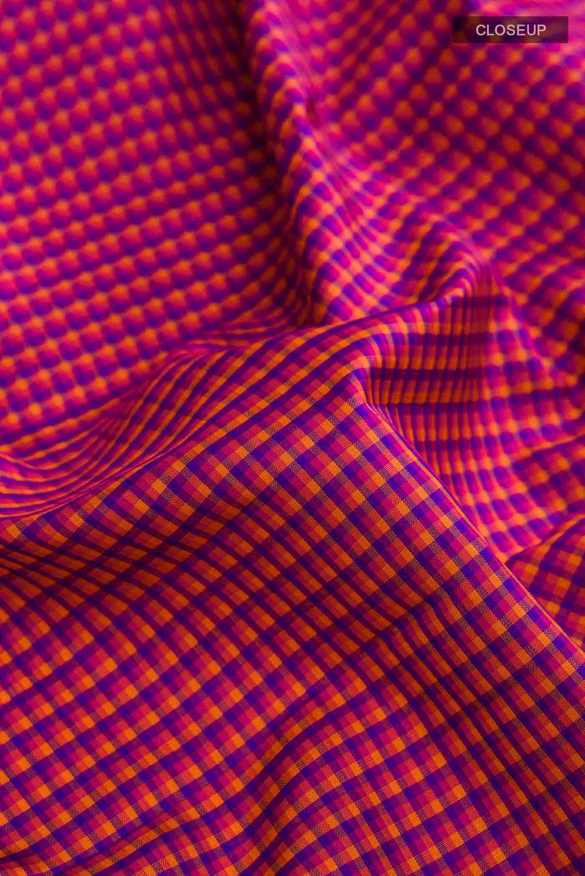 Close up of Multi Color Kanchipuram Silk Saree with Checked design on the body and Zari Border displaying folds
