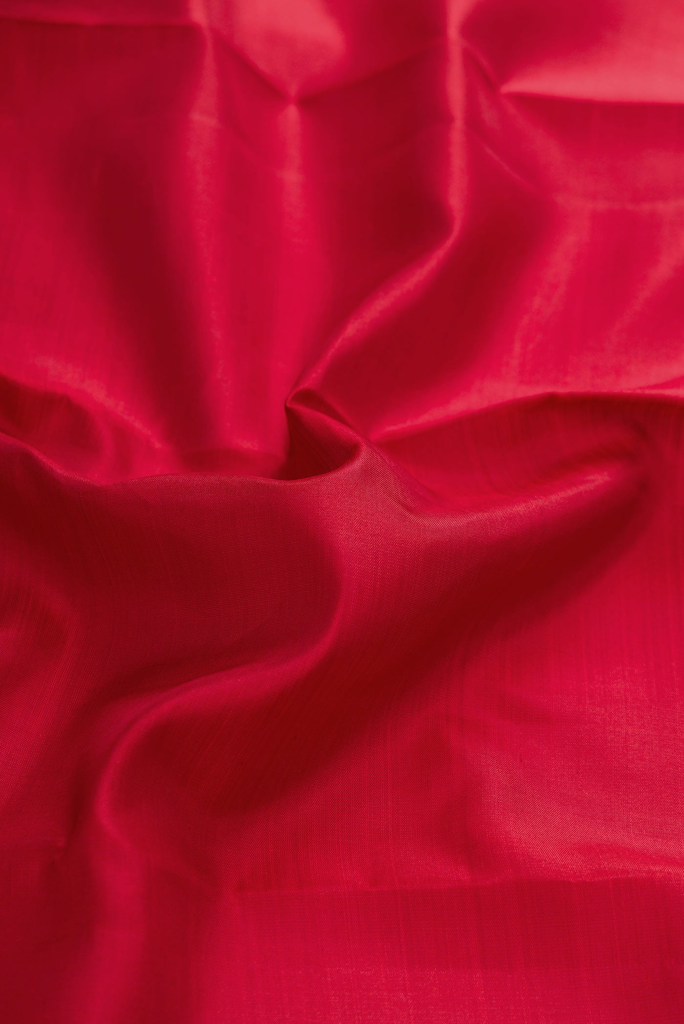 Close up of Red Dual Tone Kanchipuram Silk Saree with Plain Body and Zari Border displaying folds