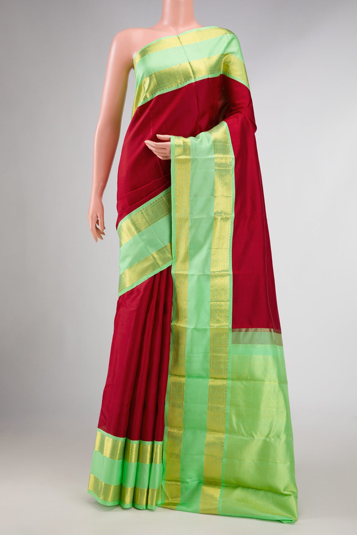 Red Dual Tone Kanchipuram Silk Saree with Plain Body and Zari Border displayed on a mannequin