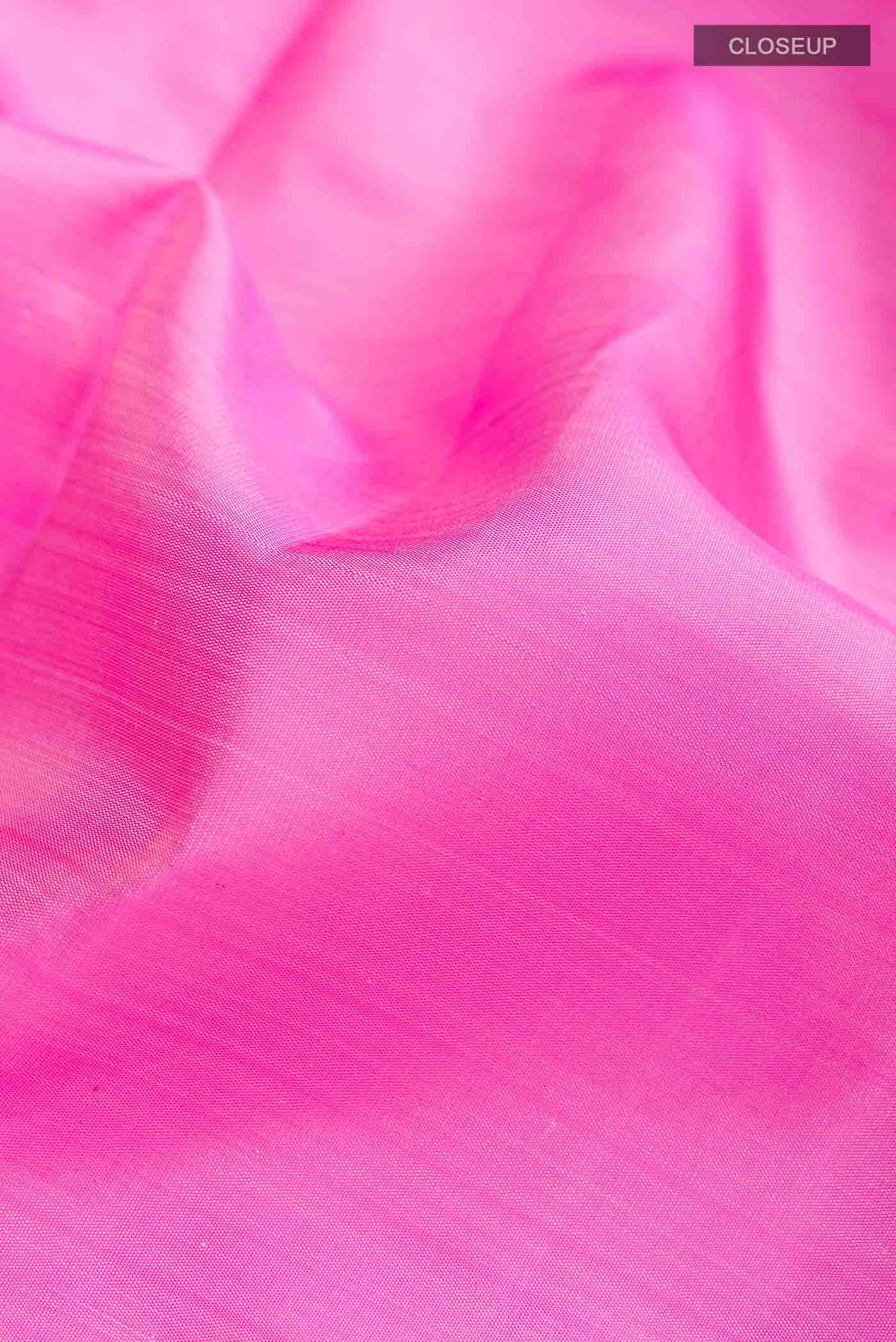 Close up of Pink Kanchipuram Silk Saree with Plain Body and Zari Border displaying folds