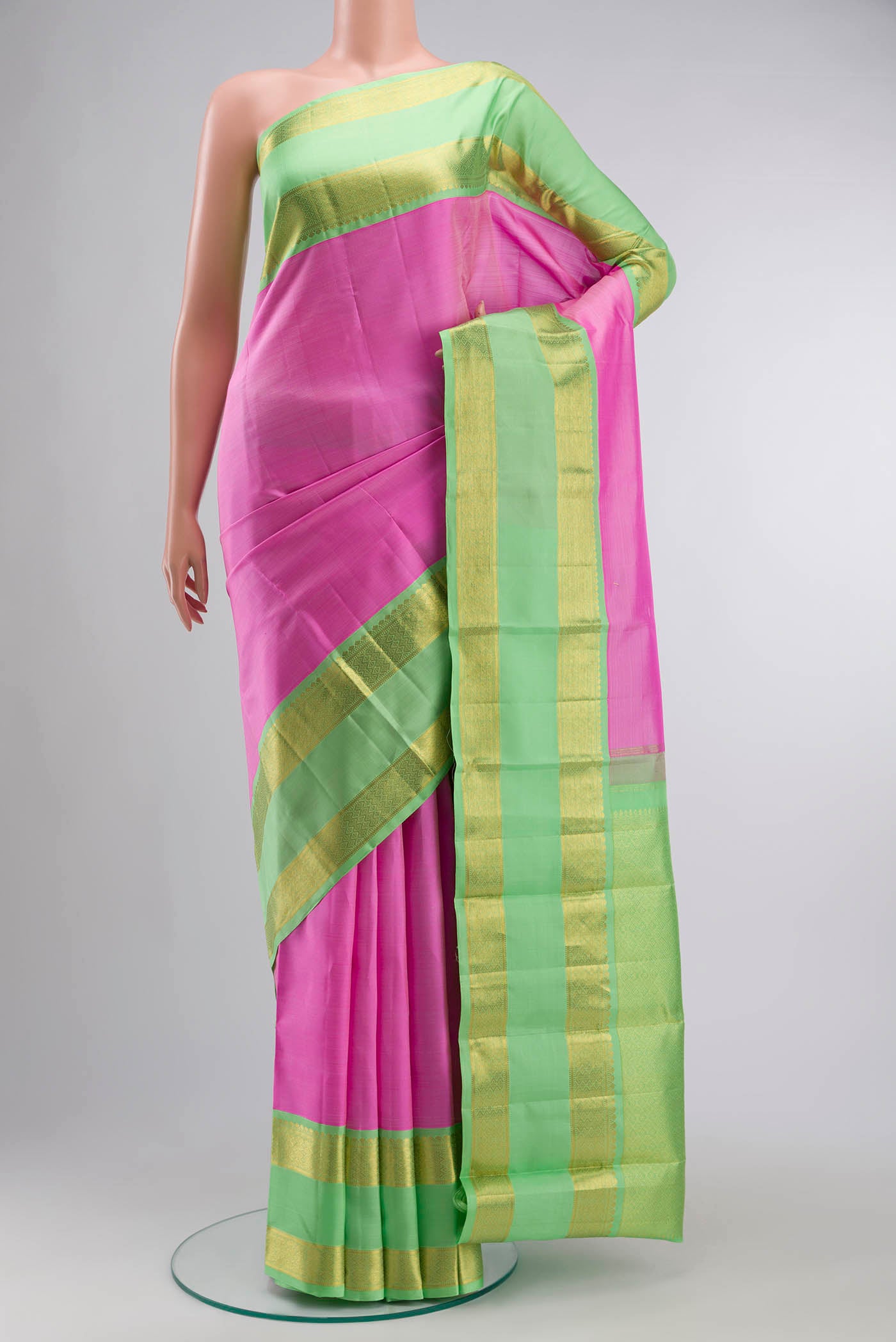 Pink Kanchipuram Silk Saree with Plain Body and Zari Border displayed on a mannequin