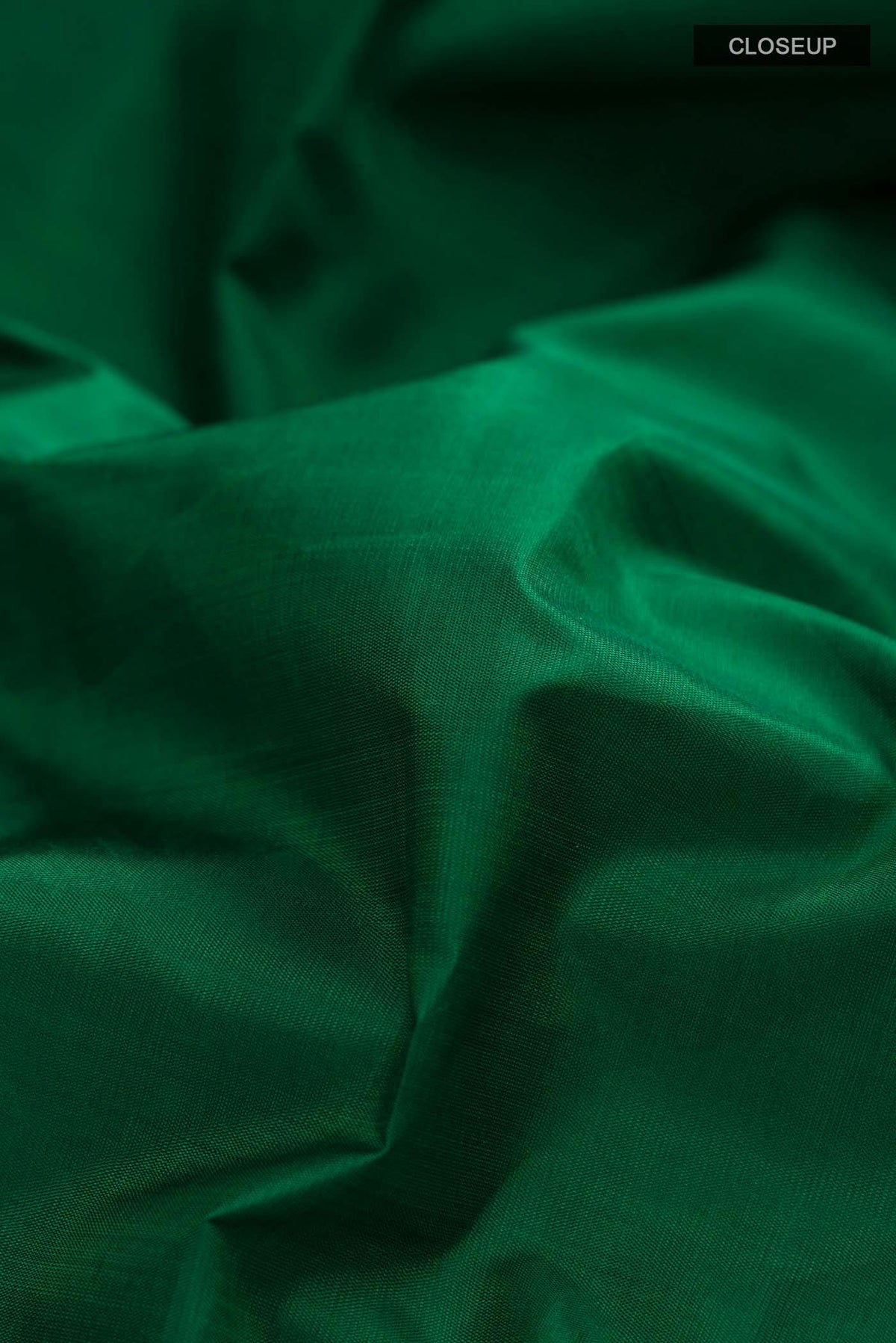 Close up of Green Kanchipuram Silk Saree with Plain Body and Plain Border displaying folds