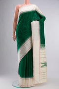 Green Kanchipuram Silk Saree with Plain Body and Plain Border displayed on a mannequin