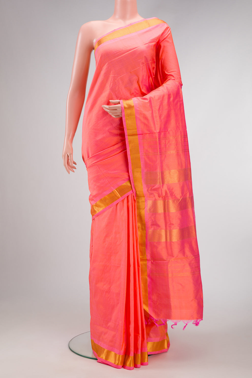Coral Dual Tone Kanjivaram Silk Nine Yards Saree with Plain Body and Zari Border.  displayed on a mannequin