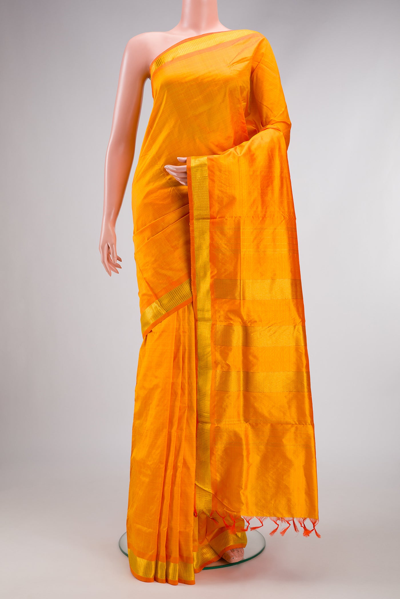 Mustard Kanjivaram Silk Nine Yards Saree with Plain Body and Zari Border.  displayed on a mannequin