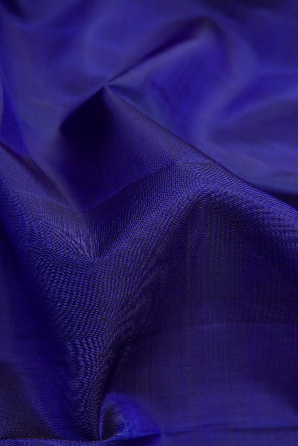 Close up of Royal Blue Dual Tone Kanjivaram Silk Saree with Plain Body and Zari Border.  displaying folds