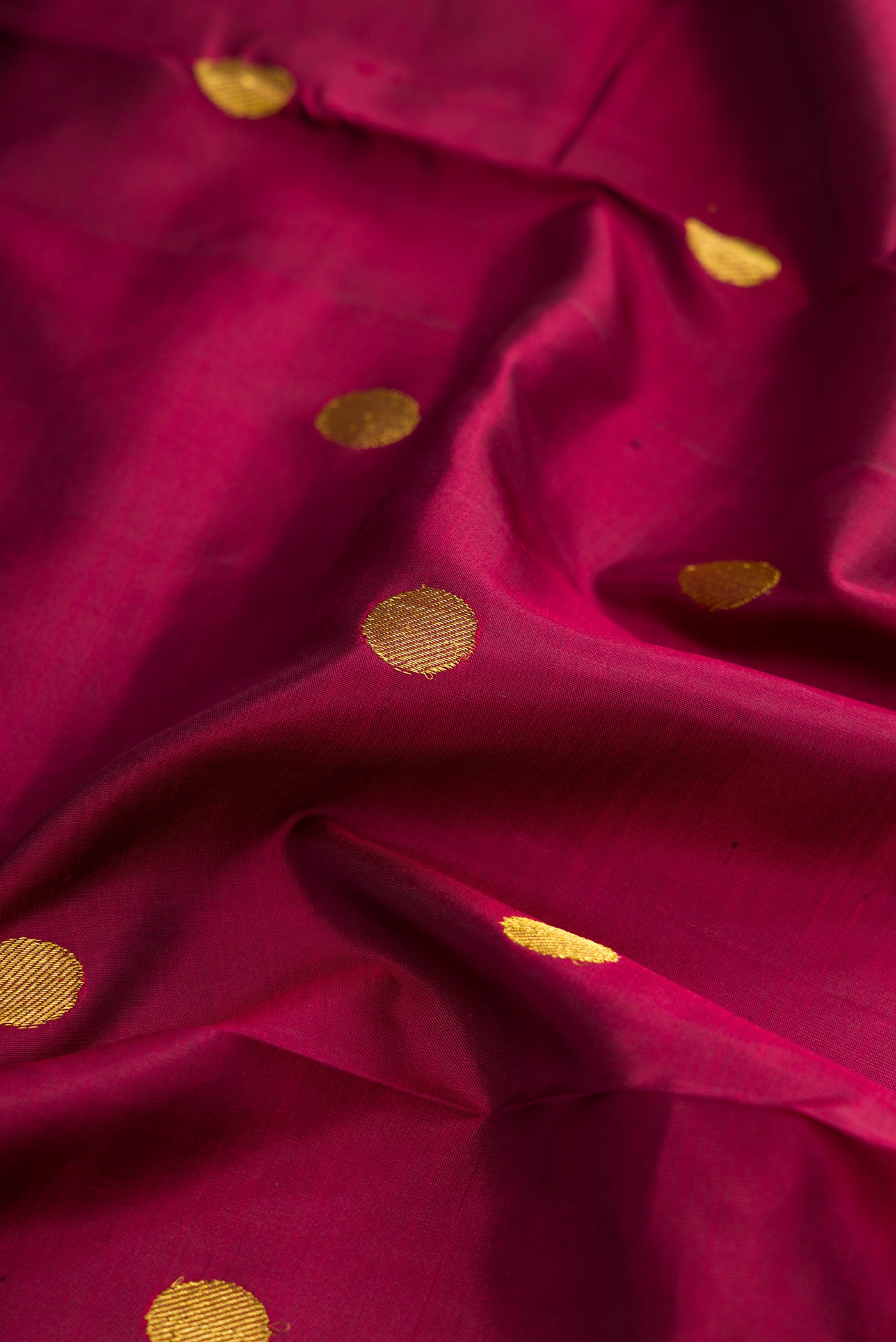 Close up of Pure Silk Pure Zari Burgundy Dual Tone Kanjivaram Nine Yards Saree with Zari Butta on the body and Zari Border.  displaying folds