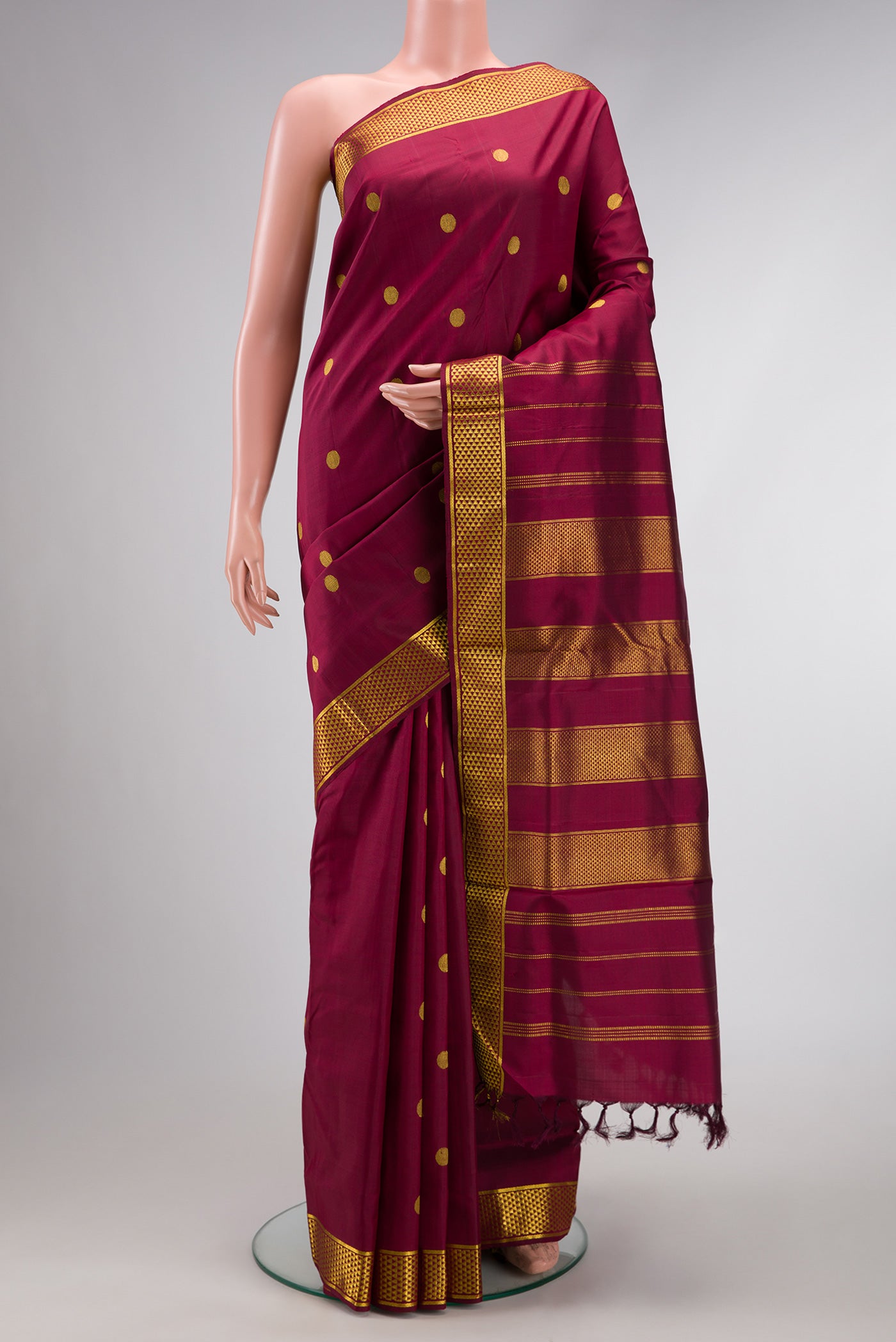 Pure Silk Pure Zari Burgundy Dual Tone Kanjivaram Nine Yards Saree with Zari Butta on the body and Zari Border.  displayed on a mannequin