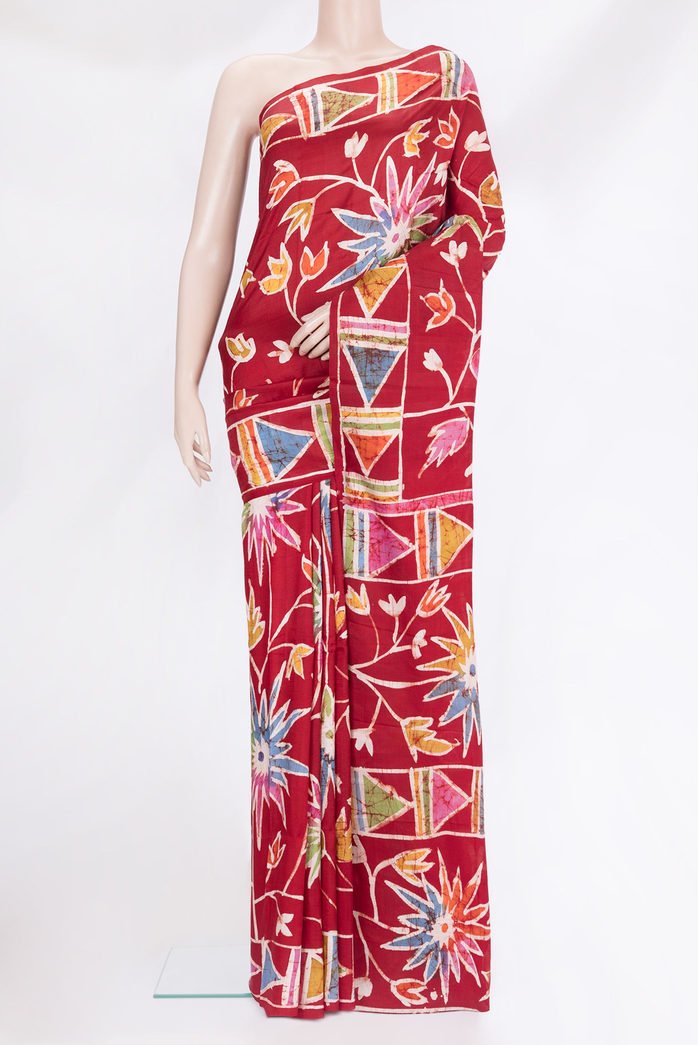 Maroon Printed Silk Saree with Batik Print on the body and Printed Border.  displayed on a mannequin