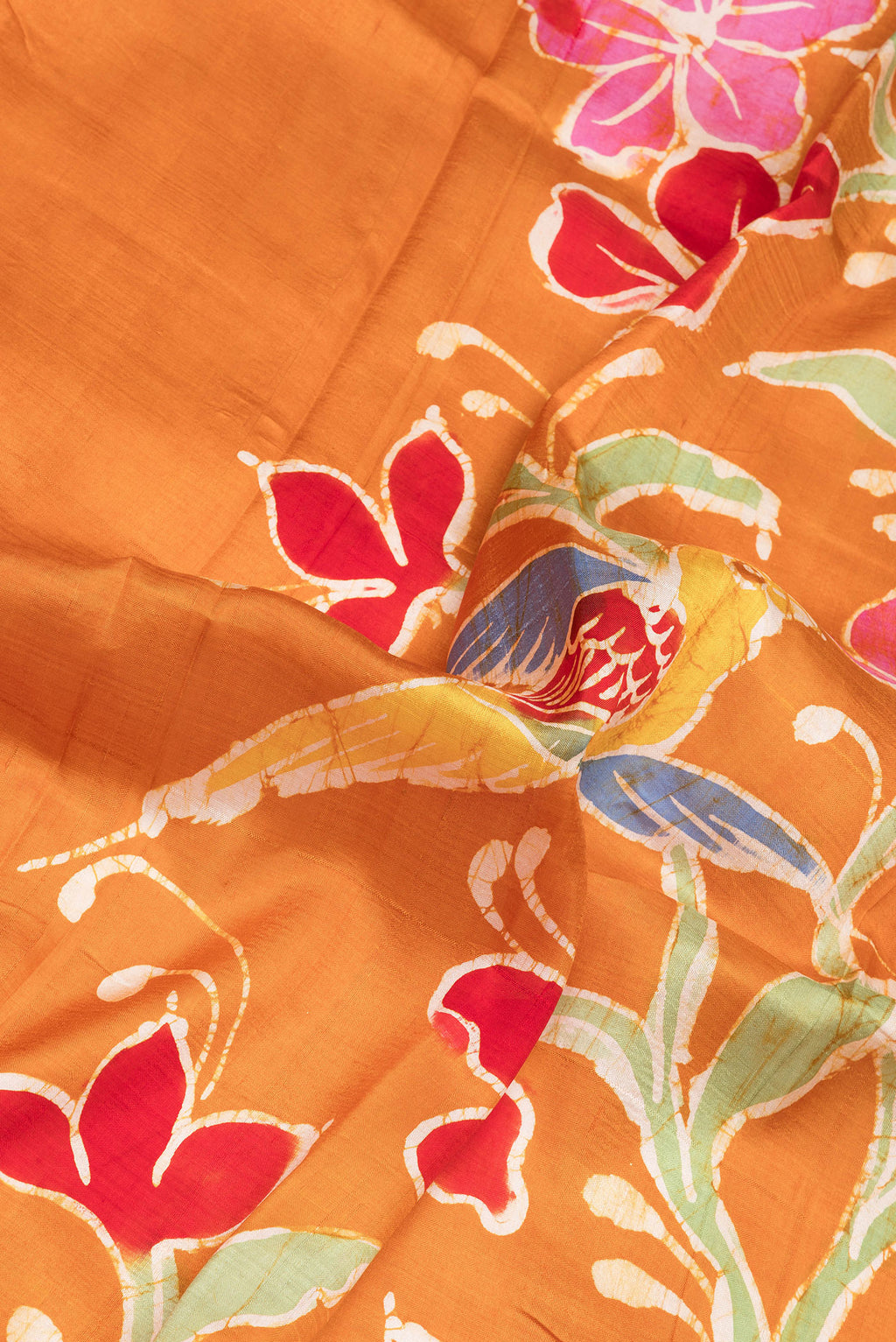 Close up of Mustard Printed Silk Saree with Printed design on the body and Fancy Border.  displaying folds