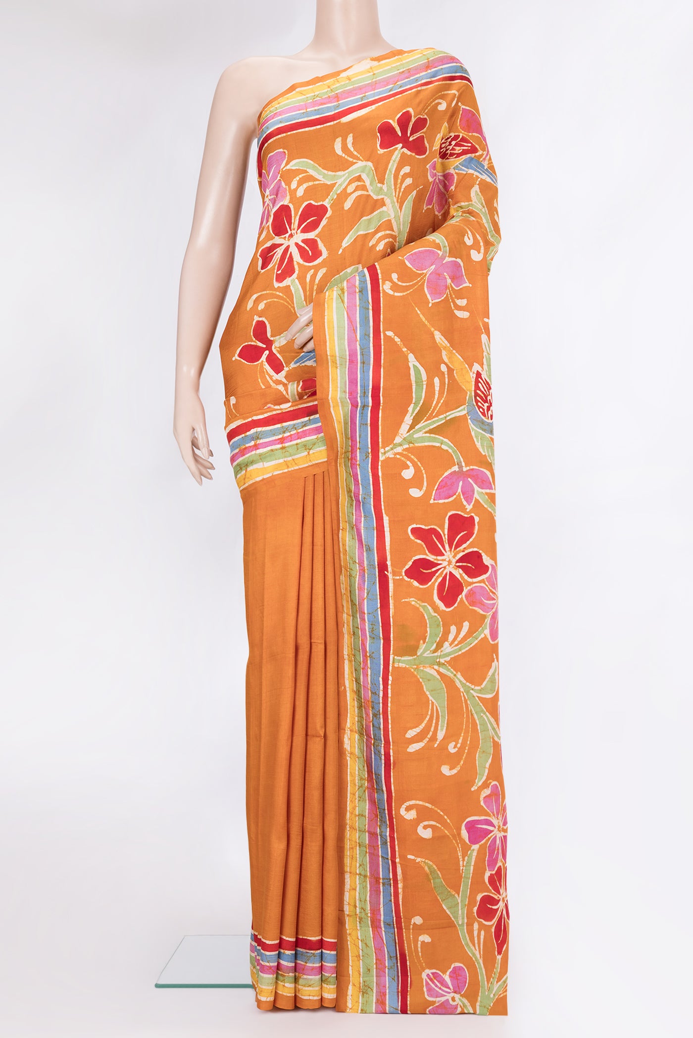 Mustard Printed Silk Saree with Printed design on the body and Fancy Border.  displayed on a mannequin