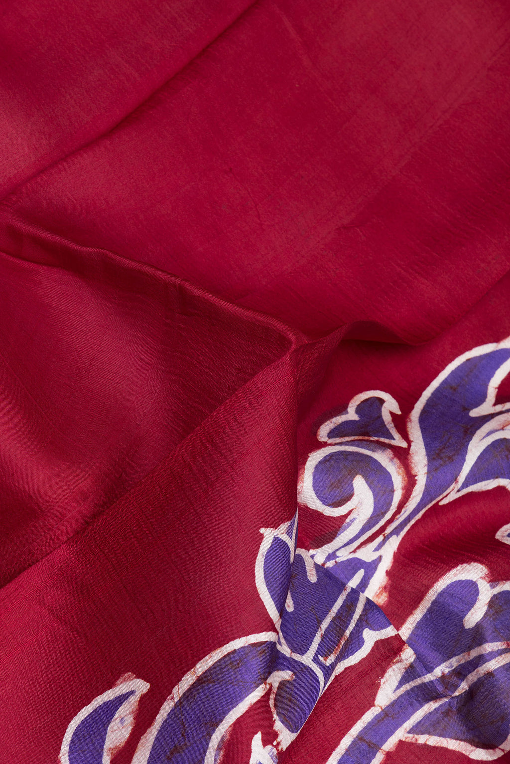Close up of Maroon Printed Silk Saree with Plain Body and Fancy Border.  displaying folds
