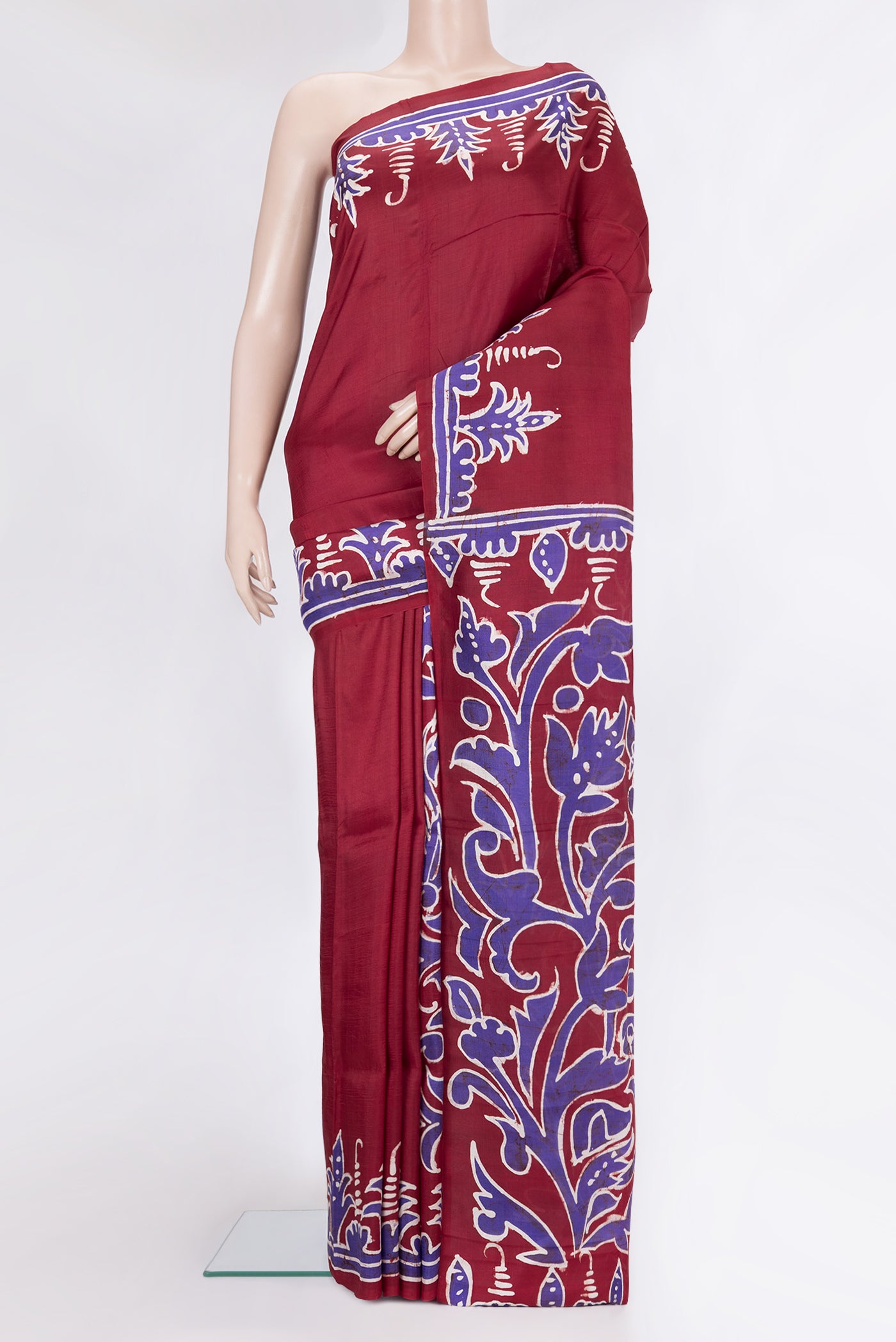 Maroon Printed Silk Saree with Plain Body and Fancy Border.  displayed on a mannequin