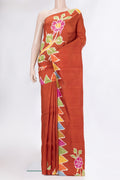 Rust Printed Silk Saree with Printed design on the body and Fancy Border.  displayed on a mannequin