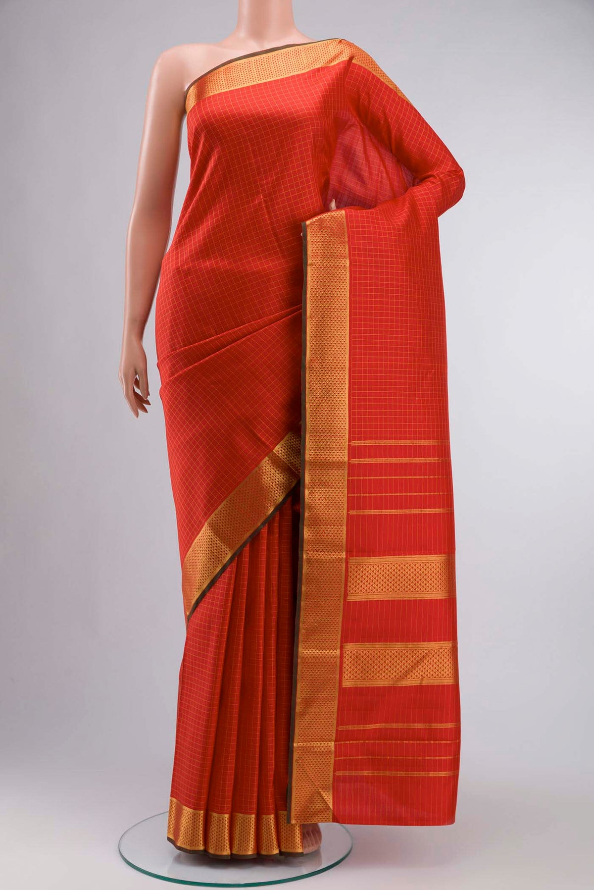 Red Kanchipuram Silk Saree Checked design on the body and Zari Border displayed on a mannequin