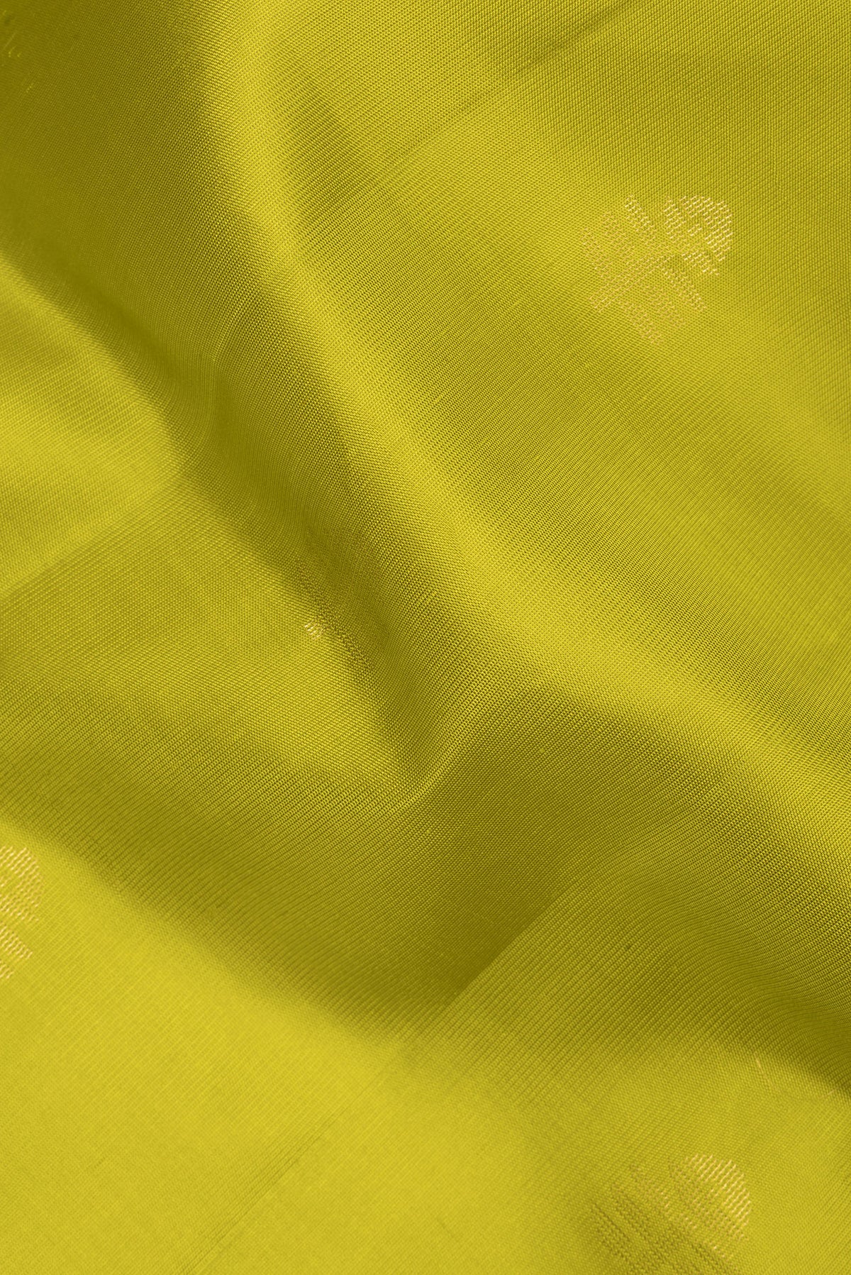 Close up of Pure Silk Parrot Green Soft Saree with Zari Butta on the body and Zari Border.  displaying folds
