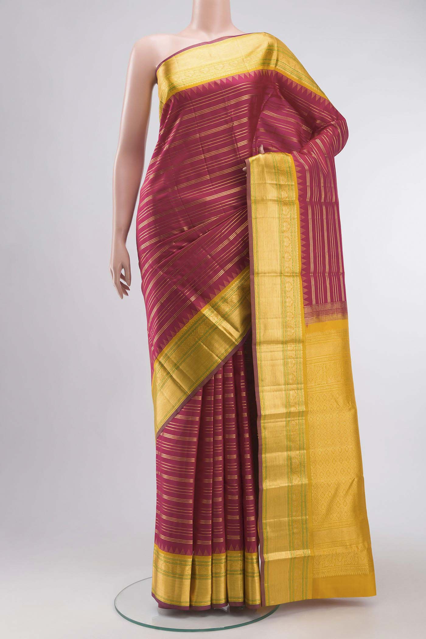 Maroon Kanchipuram Silk Saree with Stripes on the body and Zari Border displayed on a mannequin