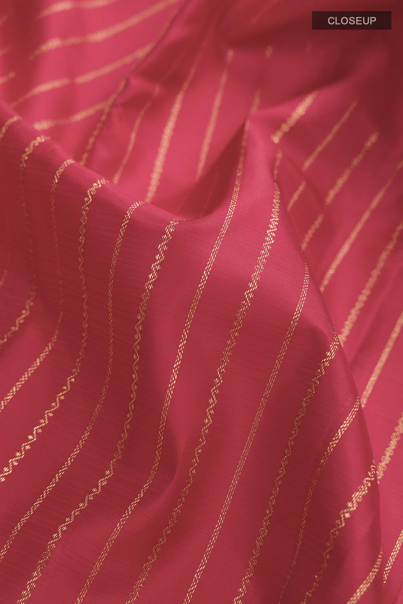 Close up of Red Kanchipuram Silk Saree with Stripes on the body and Zari Border displaying folds