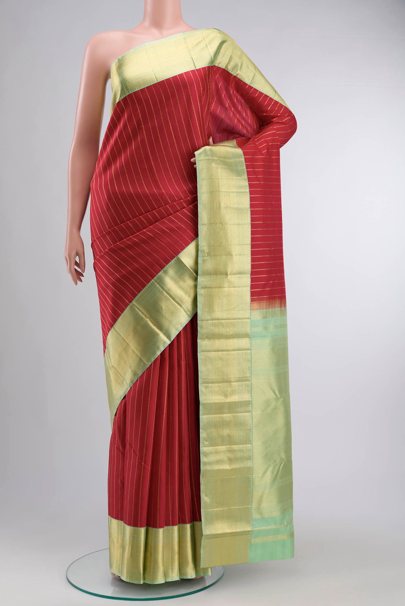 Red Kanchipuram Silk Saree with Stripes on the body and Zari Border displayed on a mannequin