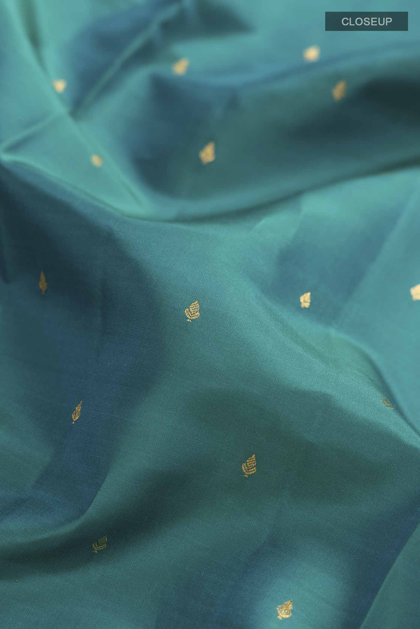 Close up of Blue Kanchipuram Silk Saree with Zari Butta on the body and Zari Border displaying folds