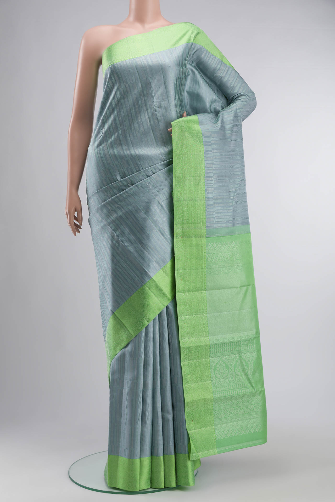 Blue Grey Kanchipuram Silk Saree with Stripes on the body and Zari Border displayed on a mannequin