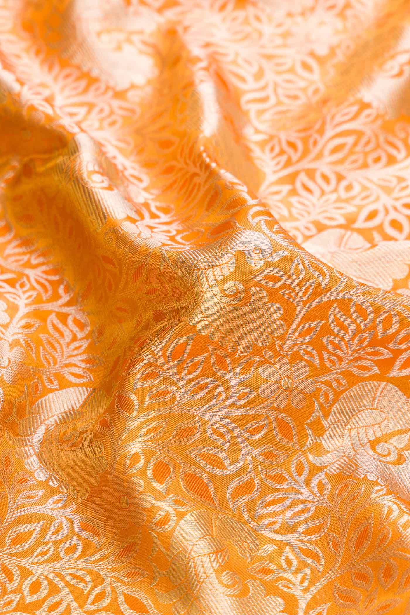 Close up of Gold Dual Tone Kanchipuram Tissue Silk Saree with Zari Brocade on the body and Zari Border displaying folds