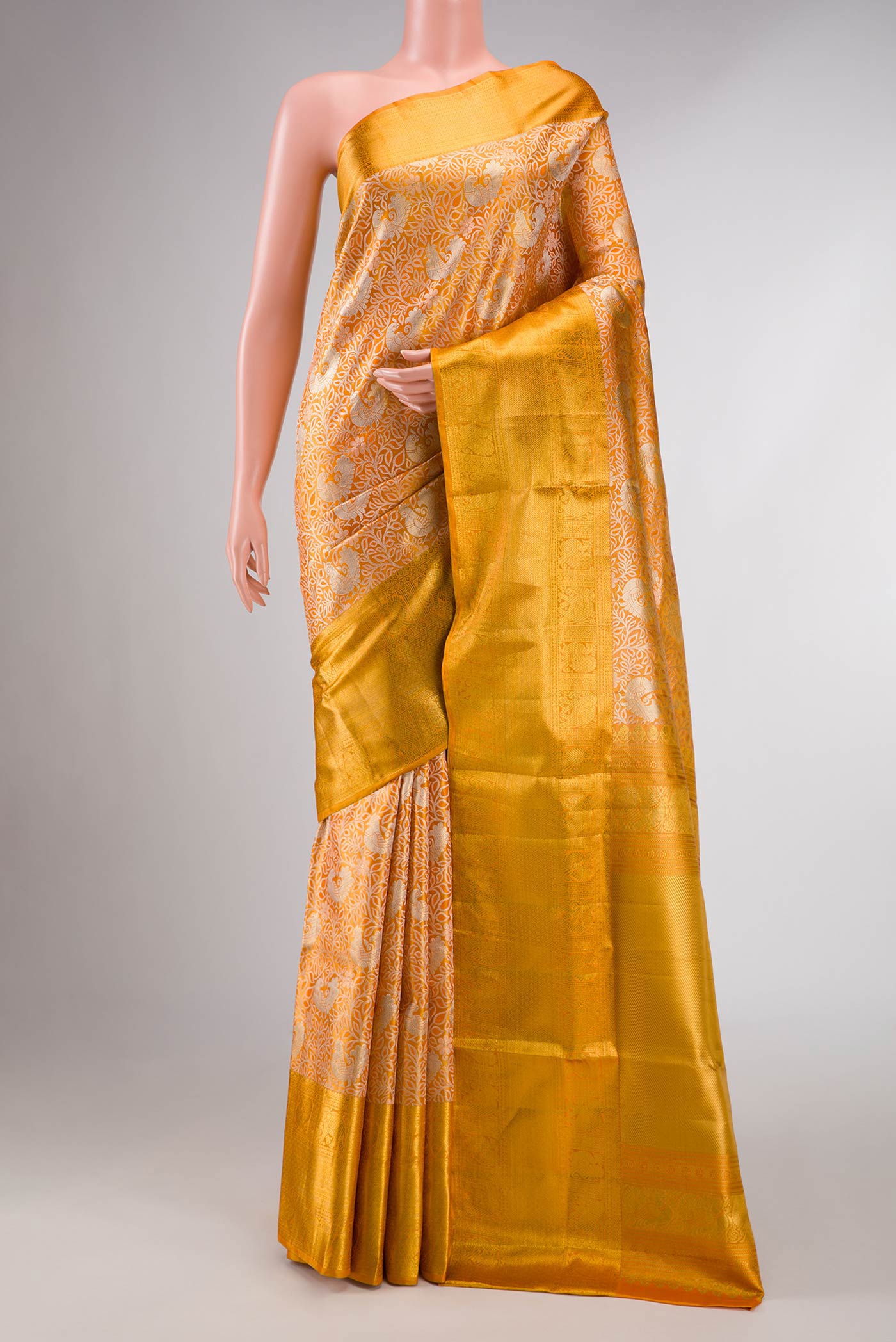 Gold Dual Tone Kanchipuram Tissue Silk Saree with Zari Brocade on the body and Zari Border displayed on a mannequin
