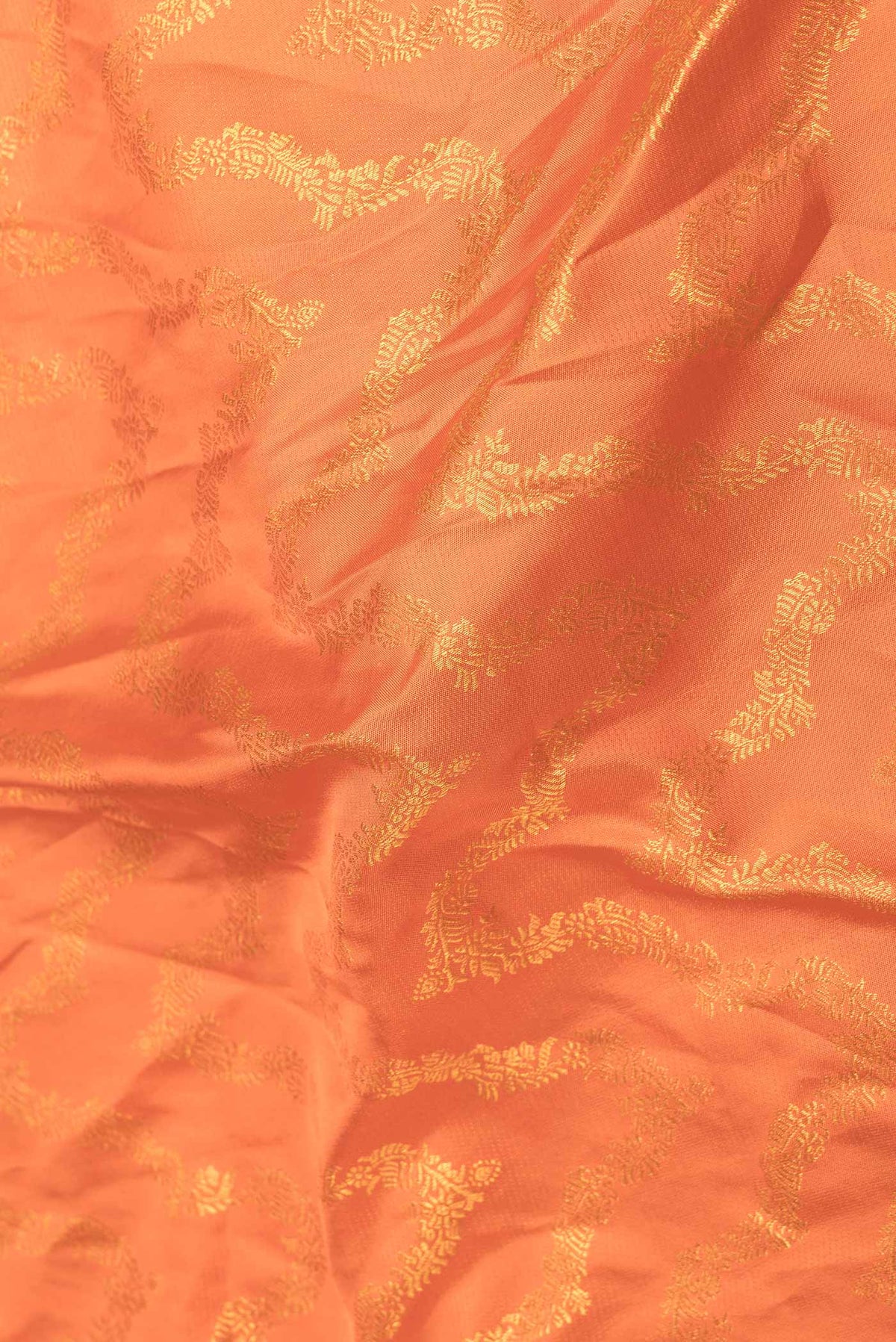 Close up of Orange Dual Tone Kanchipuram Saree with Zari Brocade on the body and Zari Border displaying folds