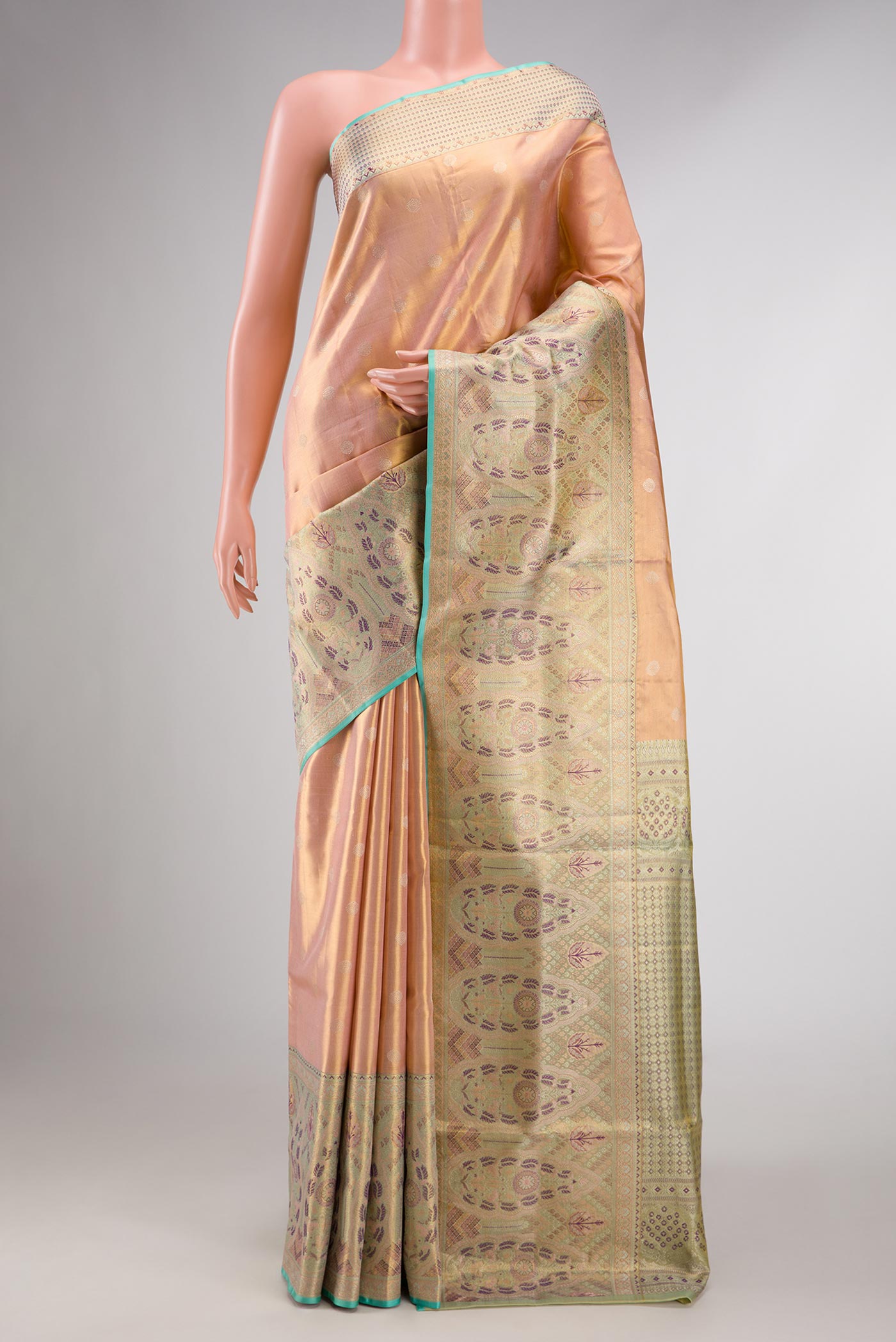 Peach Dual Tone Kanchipuram Tissue Silk Saree with Zari Brocade on the body and Zari Border displayed on a mannequin