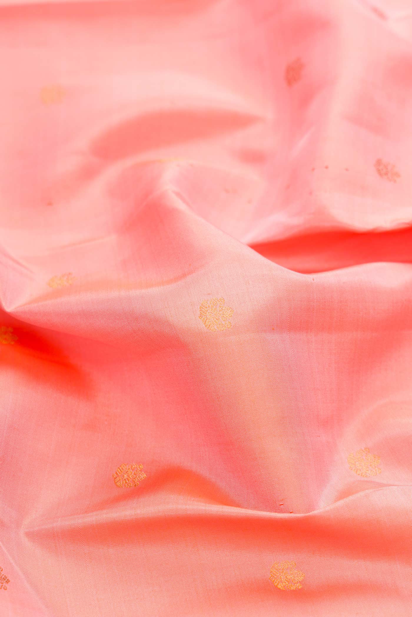 Close up of Pink Dual Tone Kanchipuram Silk Saree with Zari Butta on the body and Zari Border displaying folds