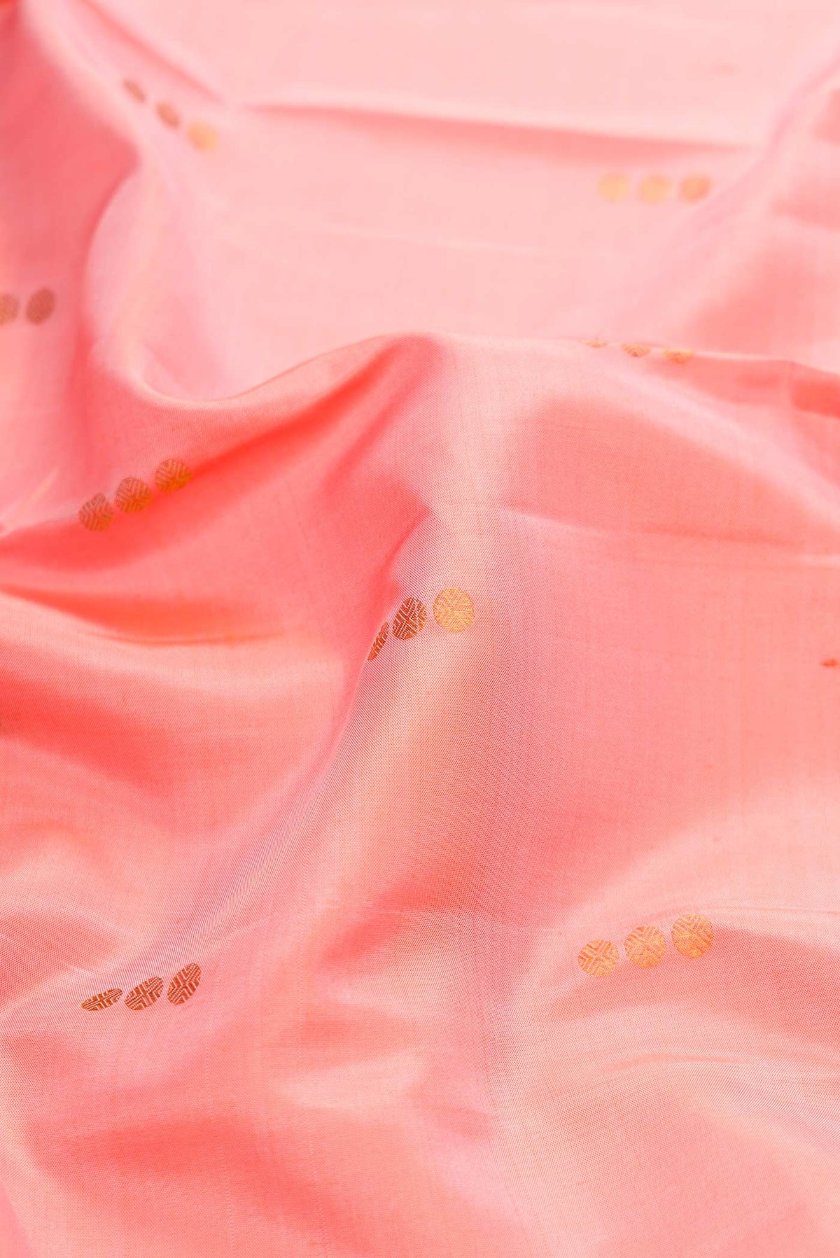 Close up of Pink Dual Tone Kanchipuram Silk Saree with Zari Butta on the body and Zari Border displaying folds