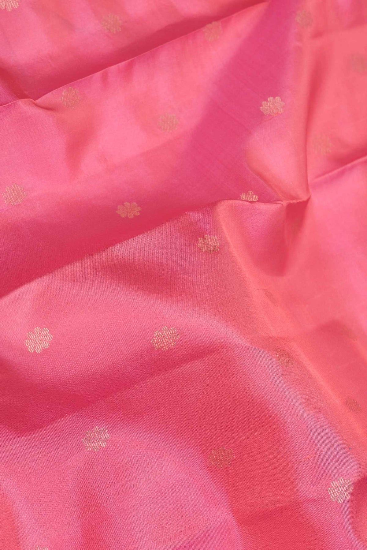 Close up of Rose pink Dual Tone Kanchipuram Saree with Zari Butta on the body and Zari Border displaying folds