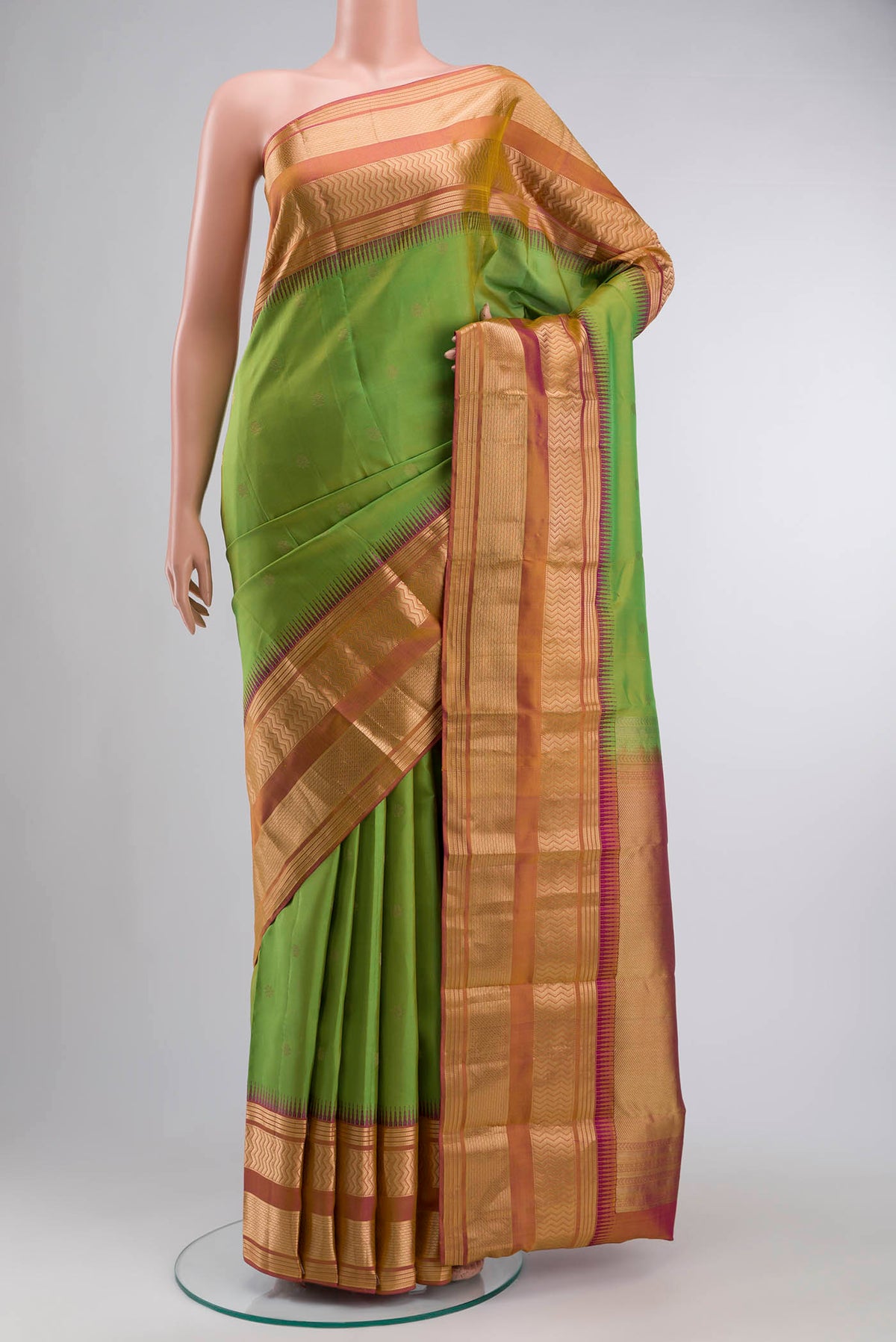 Green Kanchipuram Silk Saree with Zari Butta on the body and Zari Border displayed on a mannequin