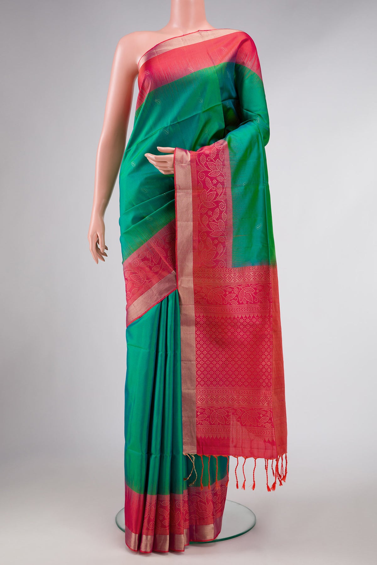 Green Dual Tone Soft Silk Saree with Zari Butta on the body and Zari Border displayed on a mannequin