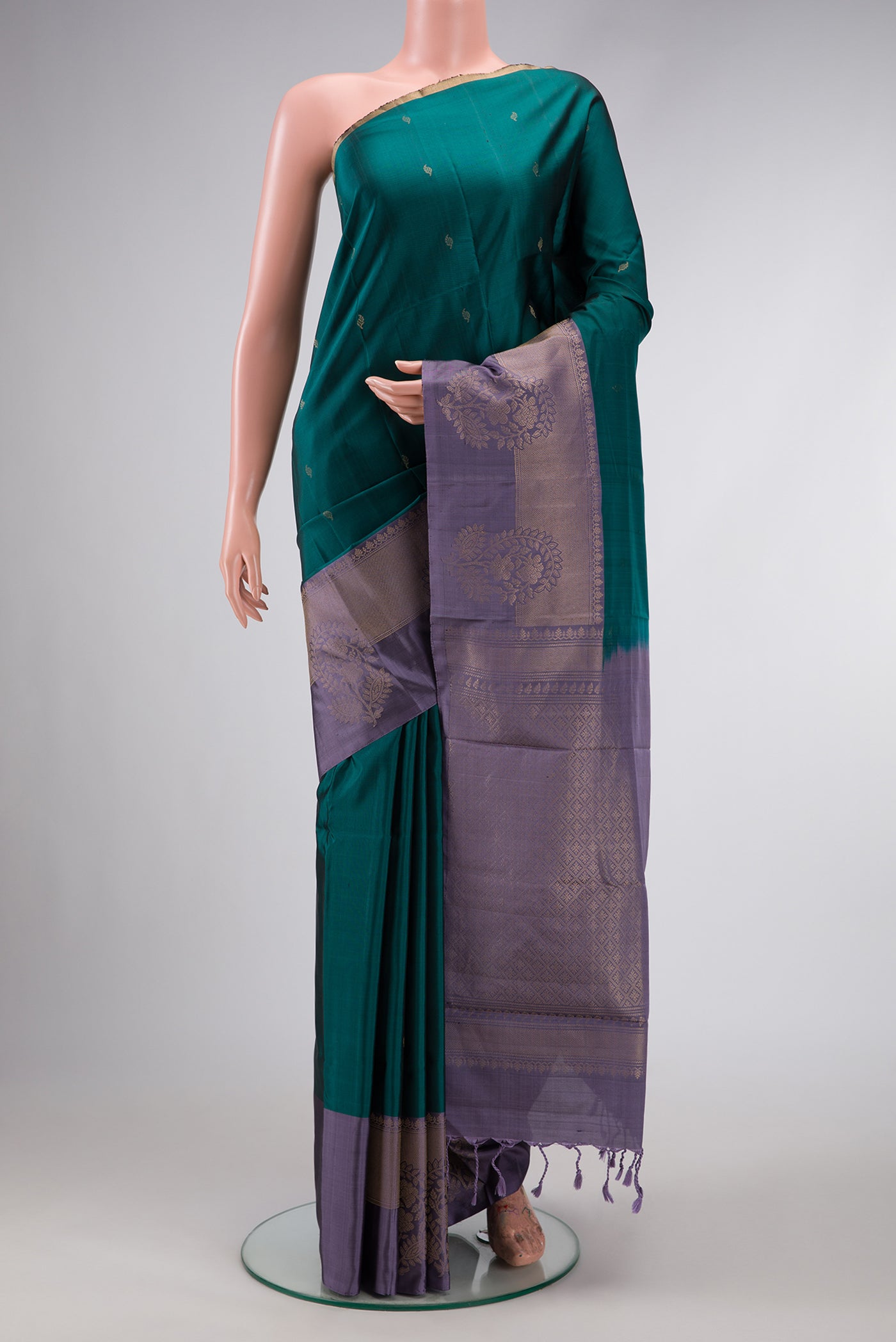 Maya Blue Dual Tone Kanchipuram Silk Saree with Zari Butta on the body and Zari Border.  displayed on a mannequin