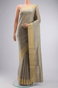 Green Soft Silk Saree with Zari Butta on the body and Zari Border displayed on a mannequin