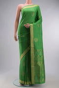 Green Soft Silk Saree with Zari Butta on the body and Zari Border displayed on a mannequin