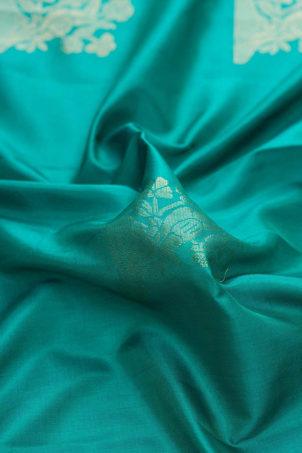 Close up of Blue Dual Tone Soft Silk Saree with Zari Butta on the body and Zari Border displaying folds