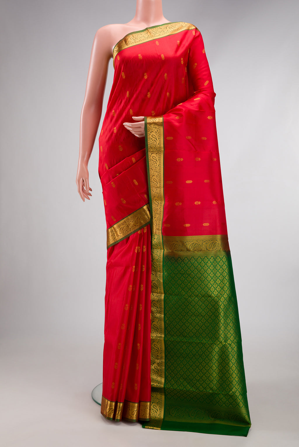 Red Kanchipuram Silk Saree with Zari Butta on the body and Zari Border.  displayed on a mannequin