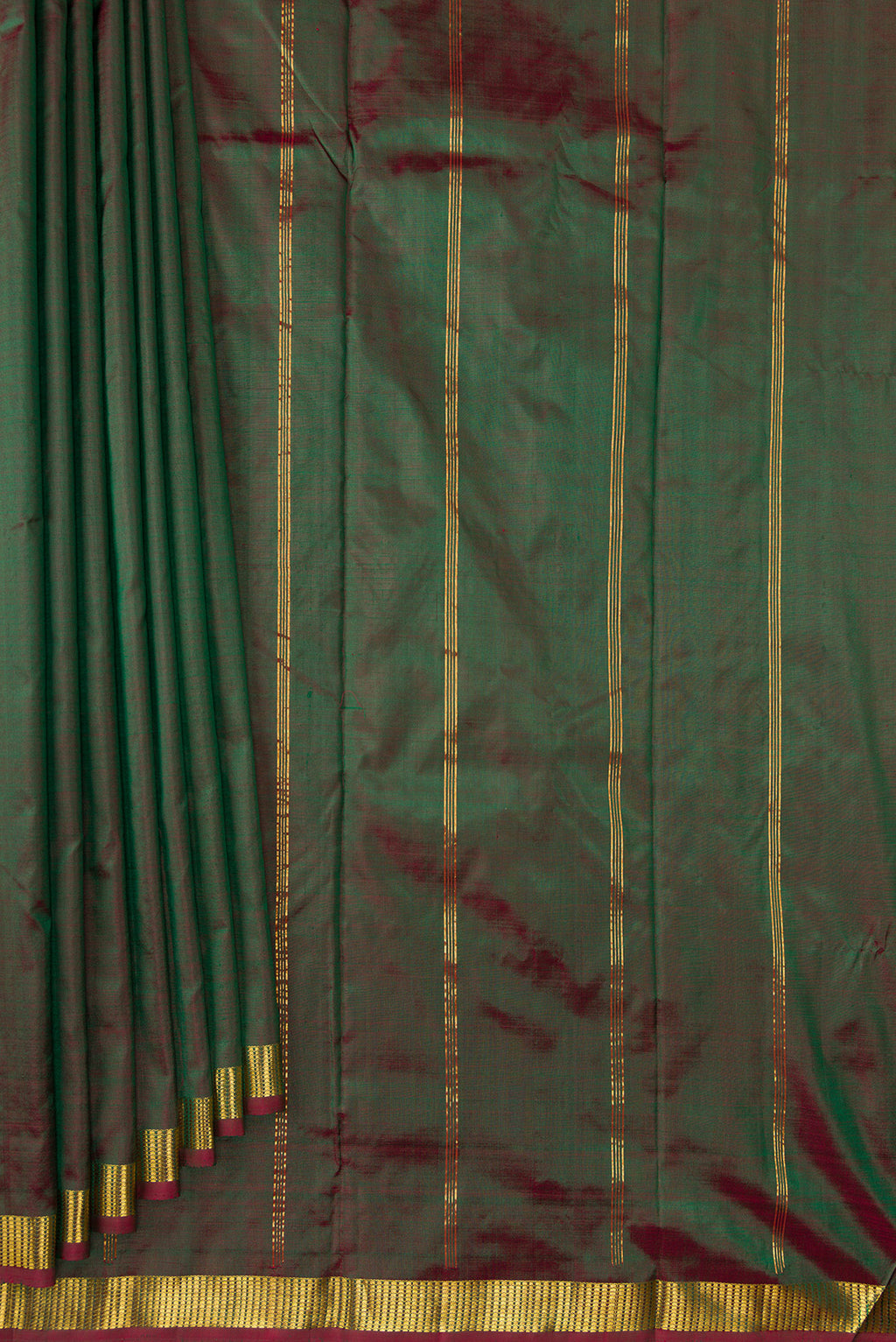 Pleats and pallu of Green Dual Tone Kanchipuram Silk Saree with Plain Body and Zari Border. 