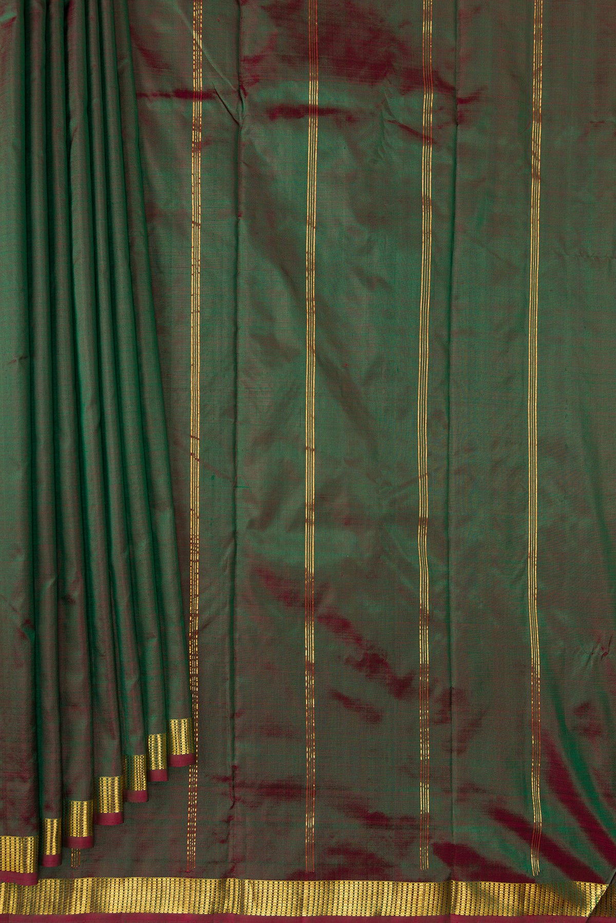 Pleats and pallu of Green Dual Tone Kanchipuram Silk Saree with Plain Body and Zari Border. 