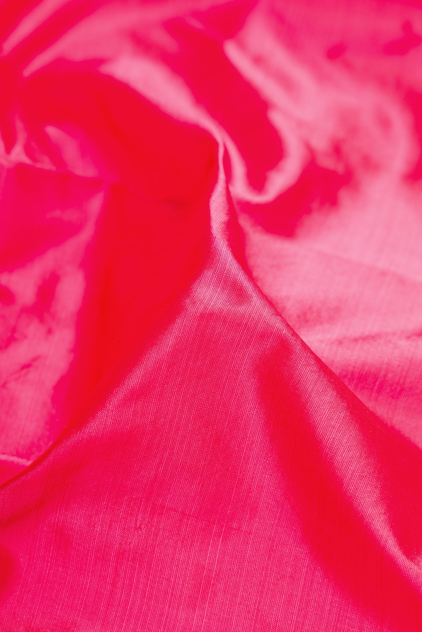 Close up of Pink Dual Tone Kanchipuram Silk Saree with Plain Body and Thread Border.  displaying folds